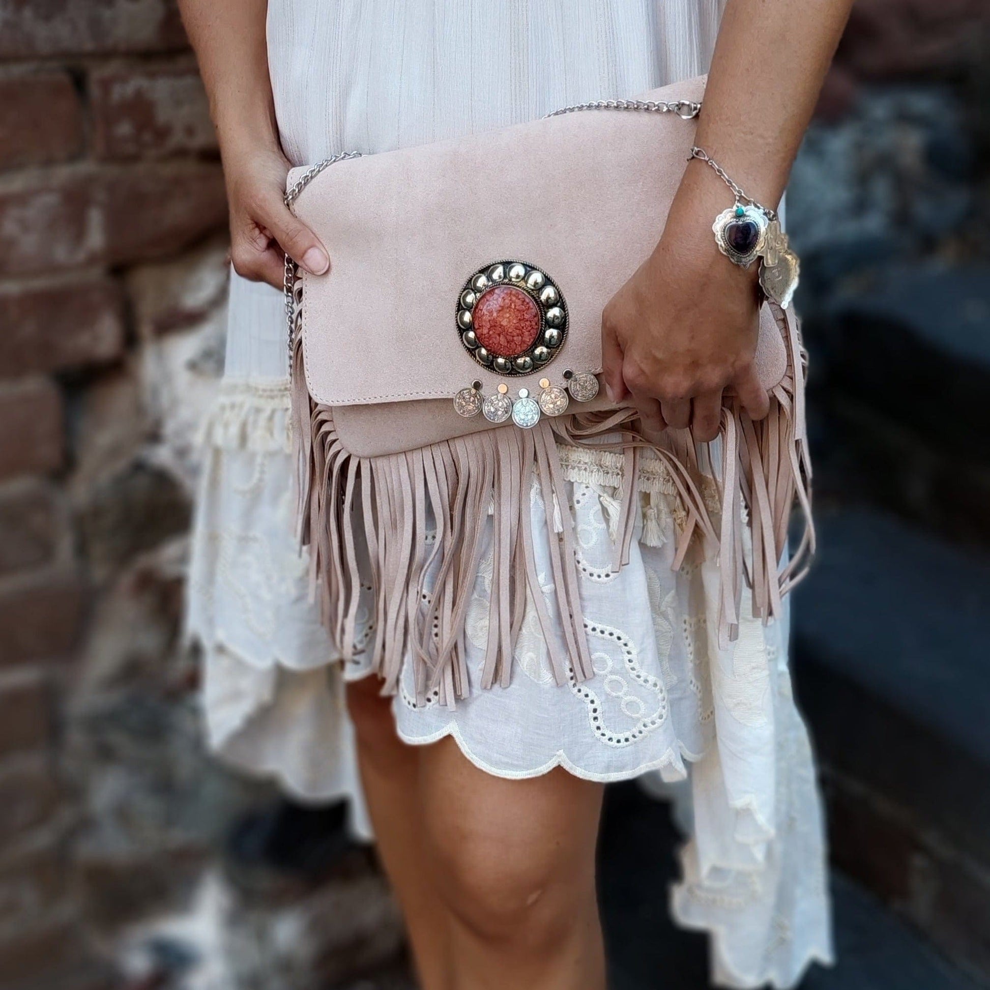 lady holding pale pink Moroccan suede crossbody bag | silver Coin & stone detail | leatherncharn